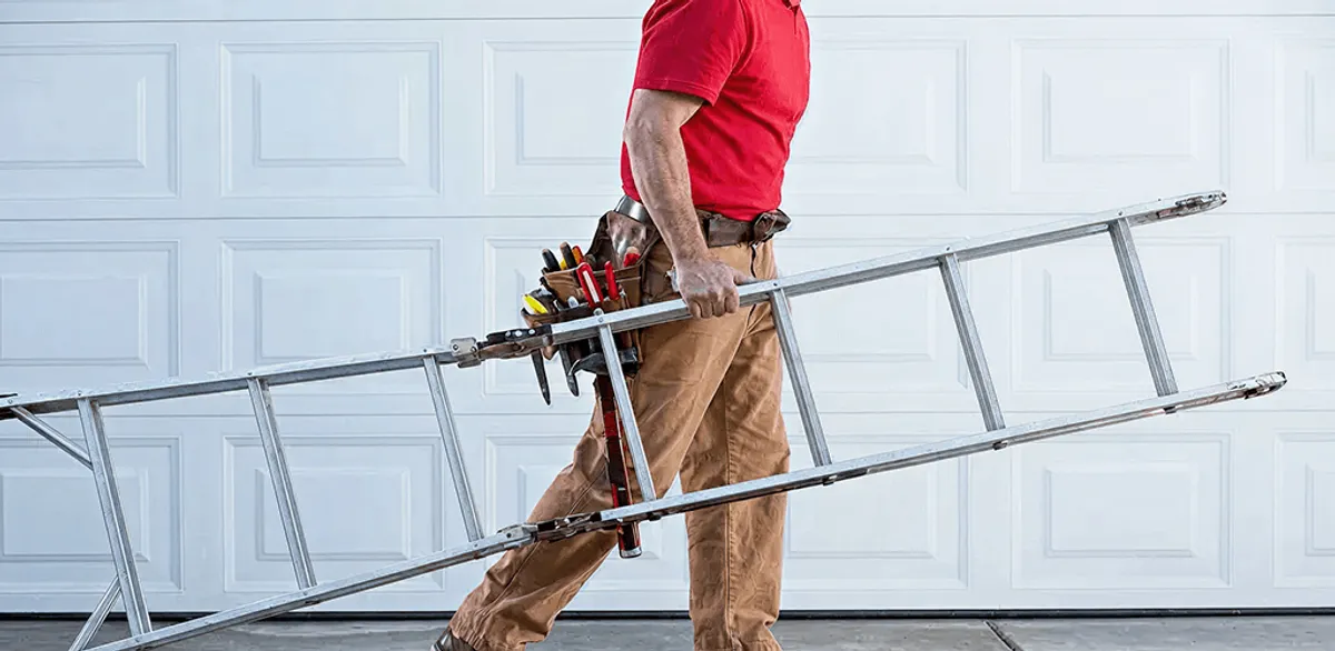 Garage door repair technician arriving with tools and ladder in Columbus, GA